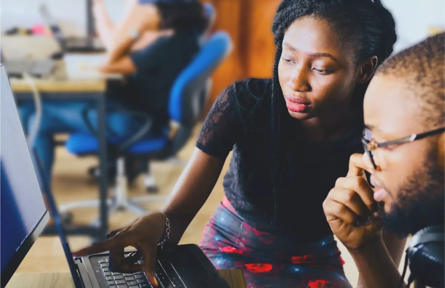 Two people working on a computer