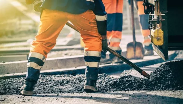 road workers laying asphalt