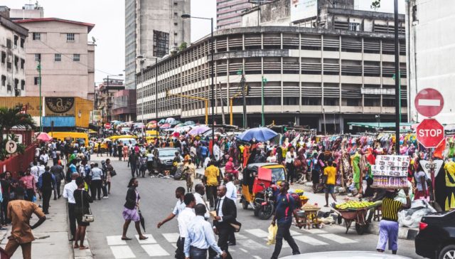 crowd of people crossing a city street