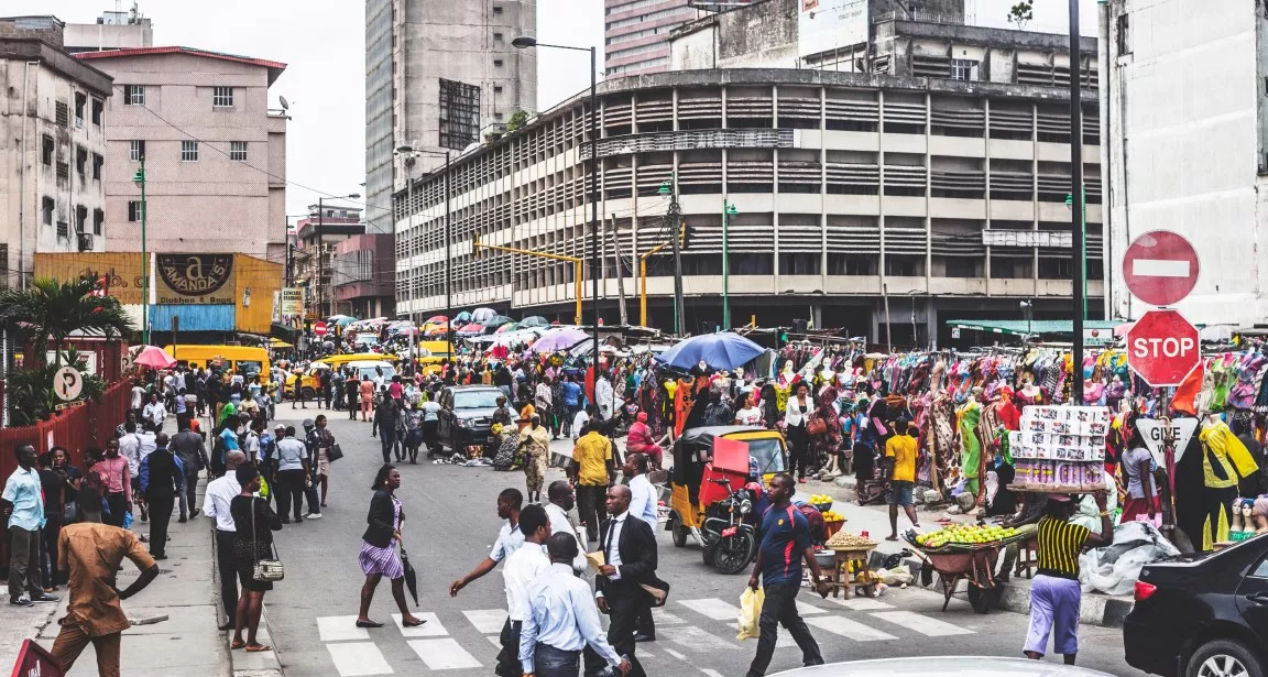 crowd of people crossing a city street