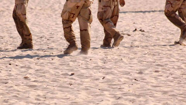 Gulf War soldiers walking on sand