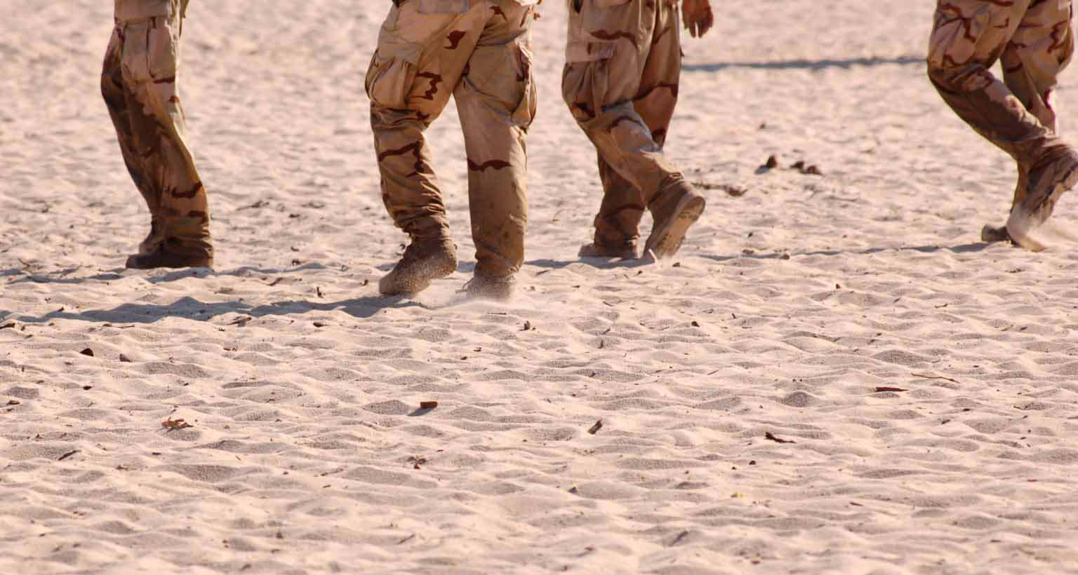Gulf War soldiers walking on sand