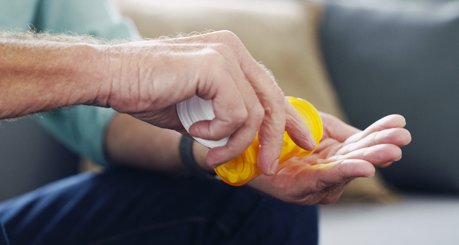 hands holding a pill bottle substance use disorder