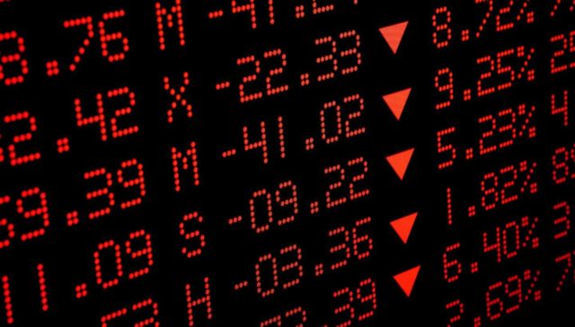 screen showing stock market prices in red