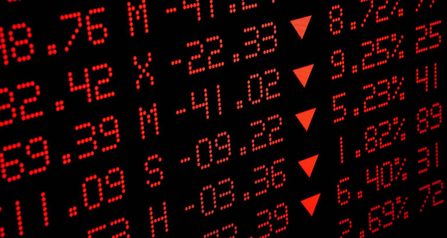 screen showing stock market prices in red