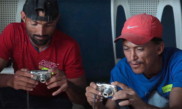 Two men using cameras to document chronic kidney disease in Nicaragua